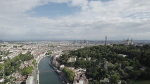 Saône river in Lyon France with Fourvière hill showing Notre Dame Basilica and Metallic Tower, Aerial pan right shot