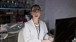 Cheeks puffed, a young and beautiful hispanic scientist woman makes a hilarious face, inflating her mouth with air while holding her breath at the lab laboratory