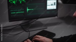 An experienced hacker creates a program for hacking bank server. On the screen is analyzed a large number of computer data necessary for the theft on the Internet.