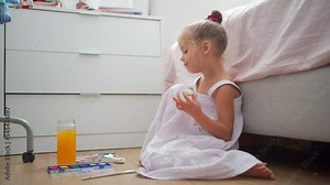 Caucasian child girl is painting watercolor paint on small ceramic figure with fun. Kids arts and crafts creative activity class at home. Little girl make ceramic decor sitting floor Stock Video