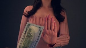 Woman reject the One hundred Dollars banknote in nominal 100 USD. Currency rate and exchange concept. Selective focus