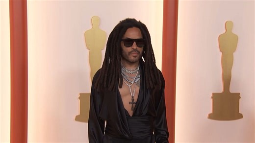 Lenny Kravitz stuns in bold red carpet look