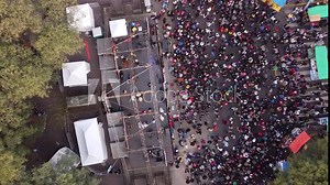 Descending aerial top down shot Chacarera folk dance on stage in street of Buenos Aires - People celebrating show outdoors