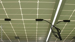 Sun power collecting sells produce alternative energy. Coiled cables with tie wraps installed under solar panels at substation close view