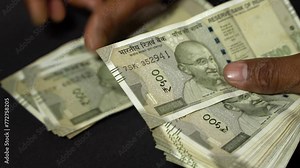 A man counting Indian rupees.