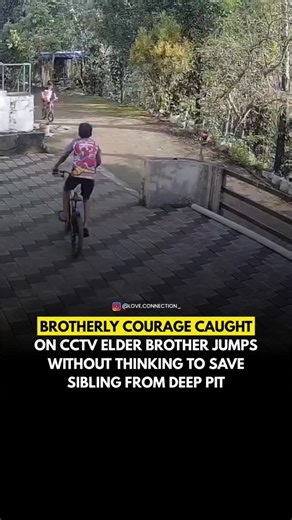 LOVE CONNECTION on Instagram: "A heart-touching incident highlighting brotherly courage has gone viral after being captured on a nearby CCTV camera. The footage shows two young boys cycling outside their home when one of them suddenly loses balance and falls into a deep pit along the roadside. Without a moment’s hesitation, the elder brother jumps straight into the pit to rescue his sibling, displaying remarkable bravery and presence of mind. The video vividly captures the strong bond between th