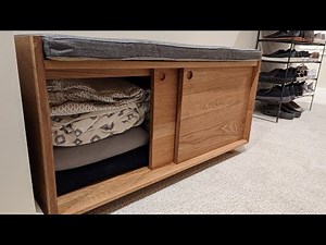 Build a closet bench with sliding doors and a cushion.