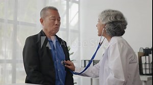 Doctor examining to old man patient by listening lungs and breathing.