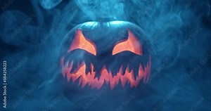 Spooky Halloween jack o lantern with glowing scary face carved out of a pumpkin and surrounded by smoke and mist.