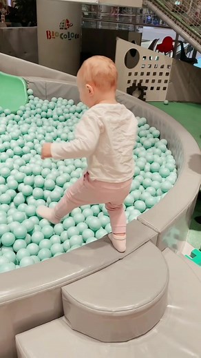 Toddler Playing in Colorful Ball Pit Adventure