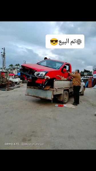 Loading a Damaged Red Car onto a Flatbed Truck