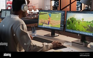 Indian Male Game Designer Using Desktop Computer With 3D modelling Software To Design Characters And World For Immersive Adventure Video Game. Man Working In Game Development Company Diverse Office Stock Photo - Alamy