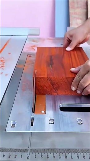 cutting wood with a table saw to create a straight edge on a thick piece of reddish timber material