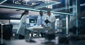 Diverse Team of Industrial Specialists Working on Remotely Controlled Mobility Robot in a Research Facility. Young Male and Female Engineers Discussing an Autonomous AI Delivery Assistant