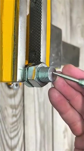 Drill bites metal core, vise holds steady, bolt yields clean hollow path