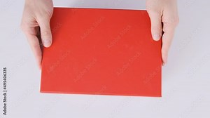 Mans hands opening and closing the lid of red gifting box. Empty box with green bottom. Top view. Chroma key