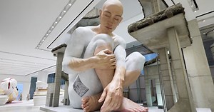 gentle monster opens shenzhen store with giant sculptures of sleeping human, bisons & faces