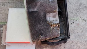 An engine air filter comparison showing an old, dirty filter next to a new, clean one. Highlights the importance of regular vehicle maintenance.