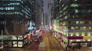 Night street traffic with many double decker buses and trams at Hong Kong city timelapse