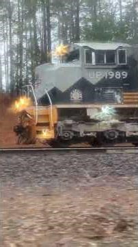 Pacing Union Pacific 1989 heritage unit in the rain.