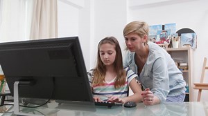 Mother and daughter working at the computer - Free Stock Video