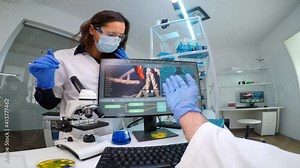 Team of microbiology scientists discussing about virus development in equipped laboratory using computer analysing test blood samples and develop vaccine, drugs and antibiotics against covid-19.