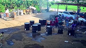 Burning oil drum explodes when worker kicks it