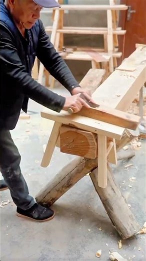 Traditional Carpenter Using a Wooden Hand Planer to Smooth a Timber Beam