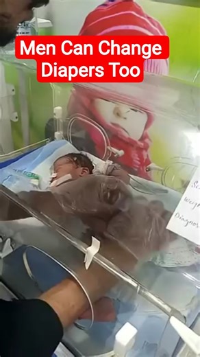 Compassion in Action: NICU Male Nurse Changing Baby’s Diaper.