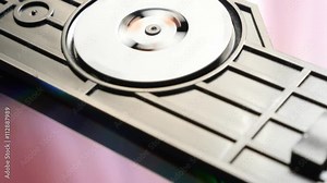 Compact disc reading mechanism starting 4K 2160p 30fps UHD video - Reading sequence after inserting DVD disk in rack 4K 3840X2160 UltraHD footage