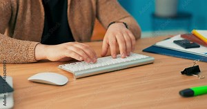 Close-up shot of hands of a Eurpean man working in an office, tapping fingers on computer keyboard, employee is pasting text, writing report, document