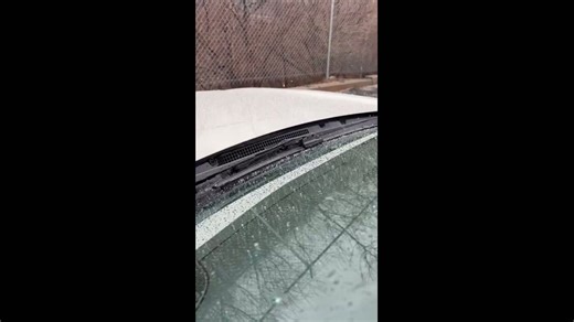 Sleet slowly accumulates on a car hood in Dunmore, Pennsylvania, USA