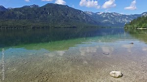 Amazing Bohinj Lake in morning. Deep clear water with fish and gorgeous landscape of Julian Alps. Triglav National Park, Slovenia, Europe.