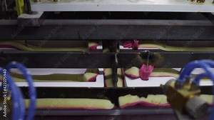 Create plastic package and packing. Machines create packing for bottles. Process of manufacturing plastic containers on extrusion equipment-moving molds and manipulator takes finished product