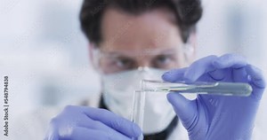 Man, scientist and vial in chemical experiment at the lab for research, discovery or testing compound at workplace. Male professional wearing safety mask and glasses with science tubes in laboratory