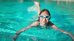 clip-1088761739-happy-girl-dives-under-water-swimming-pool