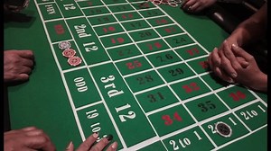 clip-3668266719-person-playing-card-game-on-green-table