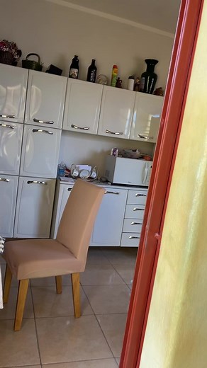 Elderly Man Enjoys Life in Charming Kitchen Setting