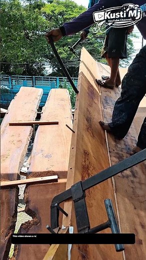 Manual Timber Alignment and Joining Process in Outdoor Wood Construction.