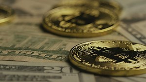 Golden bitcoin coins rotating over dollars - Free Stock Video