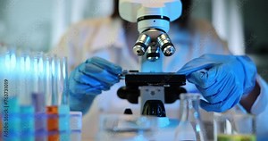 Scientist examines sample using high-resolution microscope