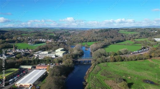 Totnes, Devon, England: DRONE VIEWS: A railway bridge over the River Dart with the South Devon steam railway station to the right and an industrial estate to the left. Totnes is an ancient market town