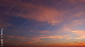 4K : Sunset sky time lapse : Timelapse video captures a sunset sky adorned with billowing clouds. Shades of pink, orange, and gold create a spectacle, painting the horizon.