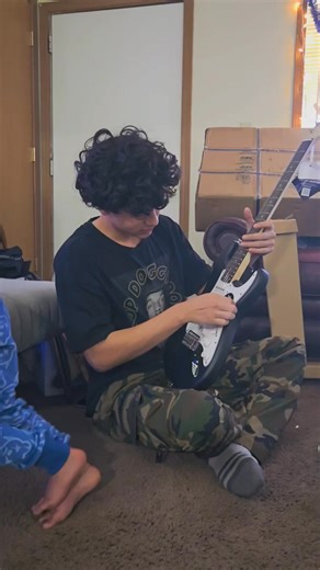 Look at that concentration! 👀 This Christmas, Gio's musical dreams just got a major upgrade! 🎁 He's been so dedicated to playing, even with a broken acoustic, and now he has the electric guitar he's always wanted. So proud of his passion and can't wait to hear all the amazing music he'll create.🌟🎸 #ChristmasPresent #GuitarDreams #FutureMusician #ProudParent #ElectricGuitar #GiftOfMusic #Christmas2025 #UnboxingJoy | Sweet Tino Bebes Journey Familia & Beyond