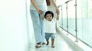 Stock video of Infant doing first steps at home.
