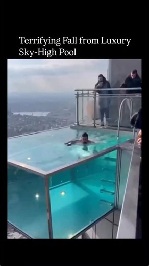 Explainer.On° on Instagram: "Post shares a viral AI-generated video of a man slipping perilously from a skyscraper infinity pool, captioned to evoke terror and uncertainty about his survival, amassing over 229,000 views in hours. The footage, circulating since December 2025 on platforms like Instagram and TikTok, simulates a glass barrier failure but stems from fabricated content, with no corresponding real-world accident documented in news sources. Replies blend visceral fear, assumptions of re