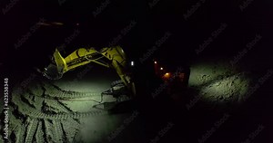 Excavator working on a open pit mine at night, slow motion