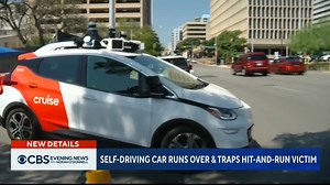A woman is in critical condition after she was hit by a car and then pinned under a self-driving robotaxi. Police are investigating the incident which is raising new questions about the safety of self-driving vehicles. | CBS Evening News