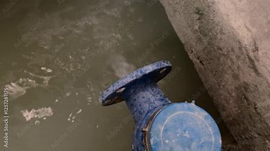 water meter that releases wastewater into a holding pond. Industrial waste water treatment procedure.