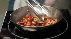 Seafood cuisine, the process of roasting crayfish, fired in a frying pan, the chef mixes ingredients, 4k slow motion.